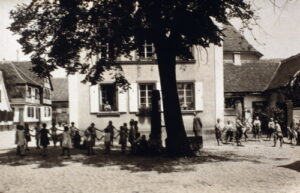 Schulpause mit Lehrer Pressler vor heutigem Rathaus, damals Schule, vor 1940